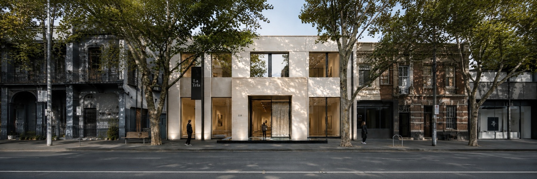 The modern La Tela archive building on a tree-lined street