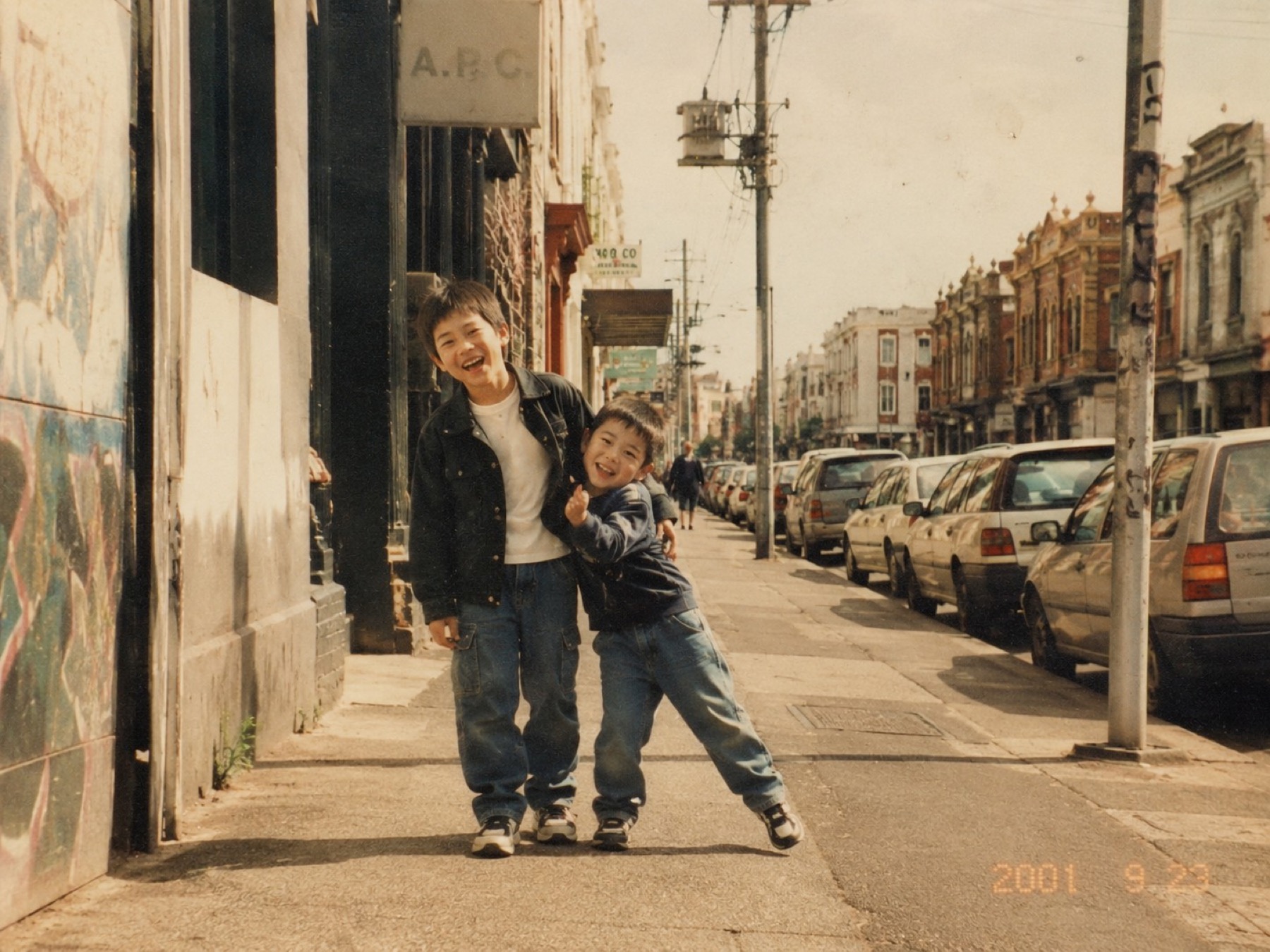 Two brothers standing together on a Melbourne street in an old photograph